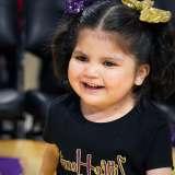 Olivia Lopez celebrates on the Los Angeles Lakers basketball court during her Laker For a Day experience.
